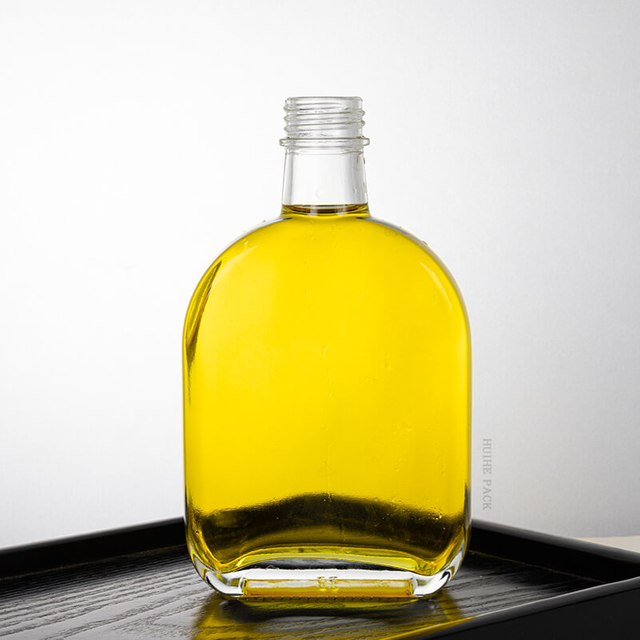 Bouteille d'alcool en verre transparent ovale avec bouchon à vis