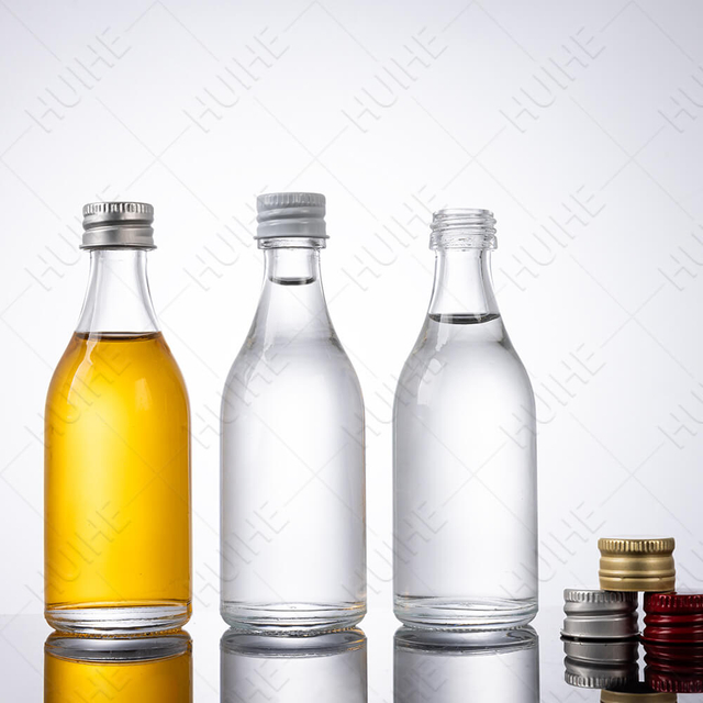 Petites bouteilles d'alcool rondes en verre de silex transparent en vrac de 50 ml