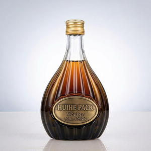 Bouteille d'alcool en verre en forme de poire avec motifs verticaux c&ocirc;tel&eacute;s